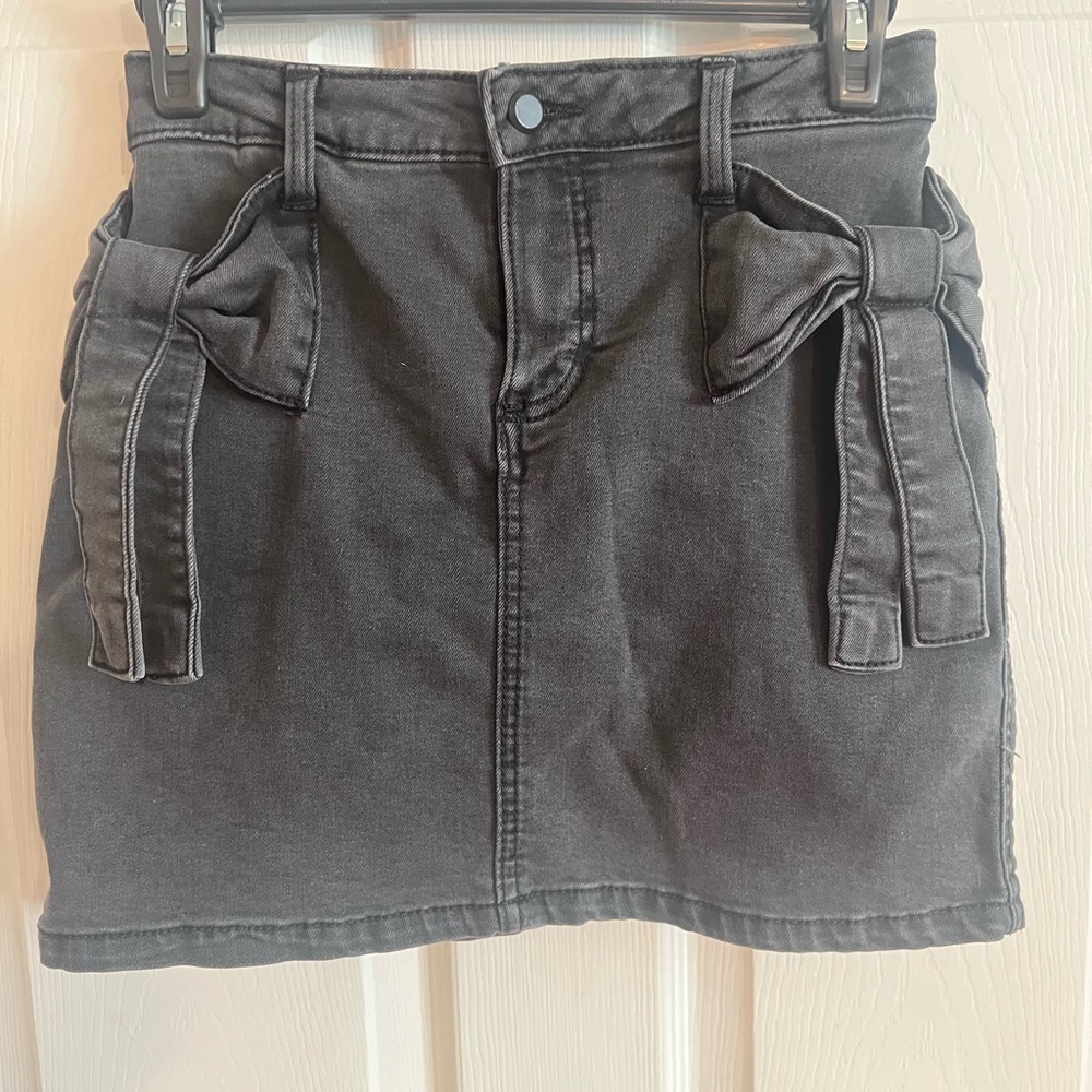 Never worn, charcoal gray Denim Skirt (with shorts under) with Bow Accents